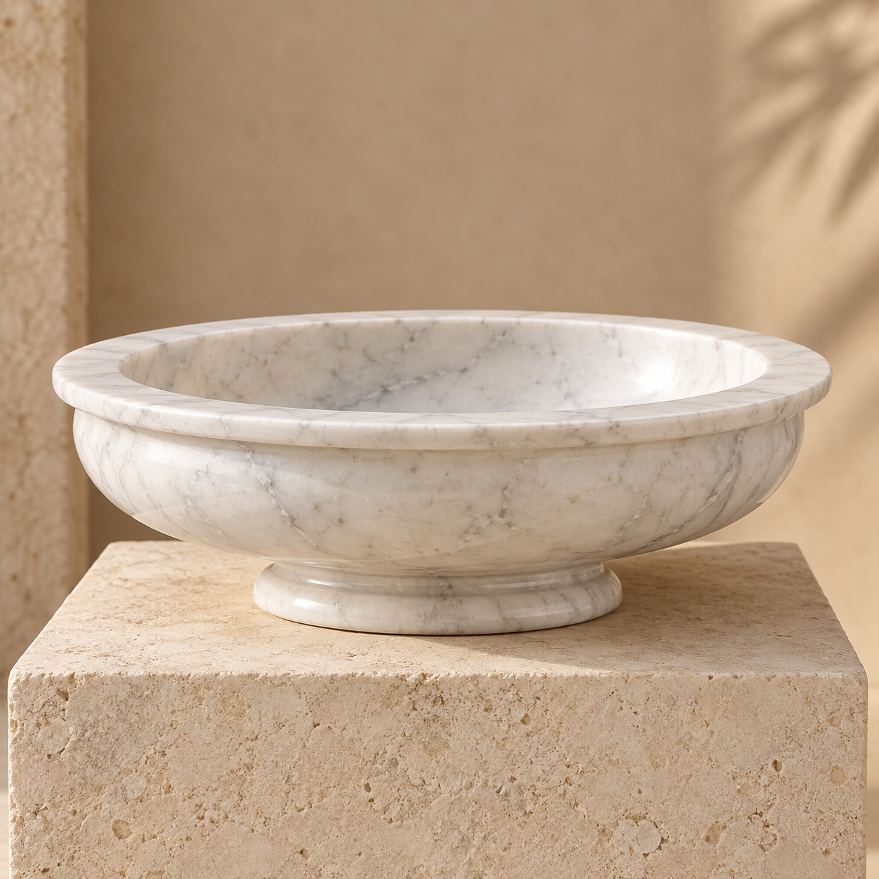 V White marble decorative urli bowl on a neutral pedestal